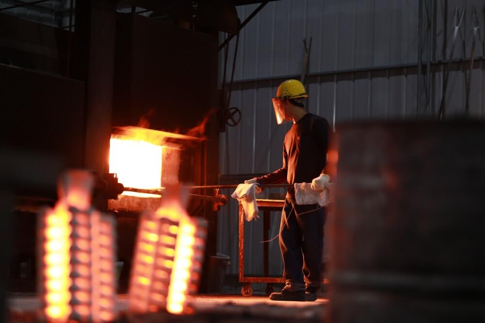 Investment casting workers are fetching the baked ceramic shell.